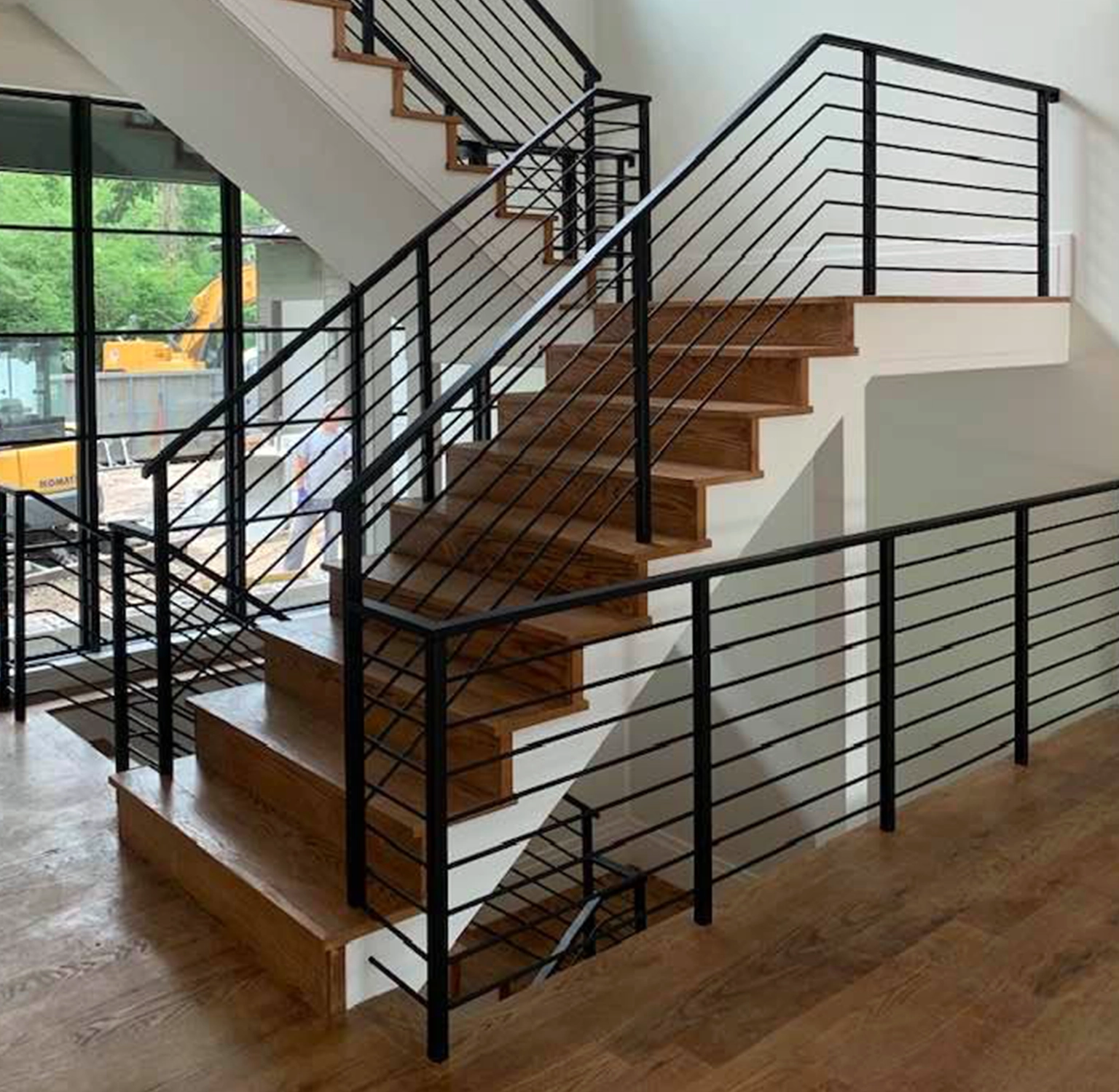 Indoor stair case with custom wrought iron railings