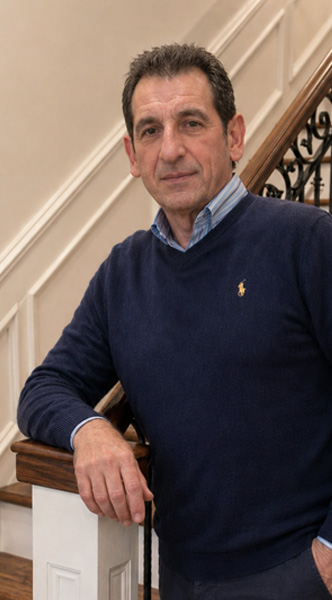 Picture of owner of AP Iron Design, Anthony Pescara, standing by custom iron railing
